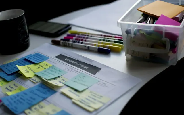 Project notes and highlighters on a work table