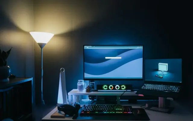Two monitors and a keyboard in a workspace