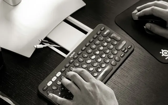Hands typing on a typewriter
